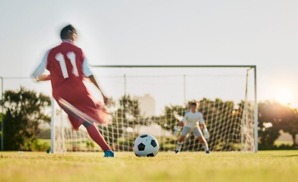 Soccer, goal post and ball, soccer player running and kicking to score goals, motivation on grass s