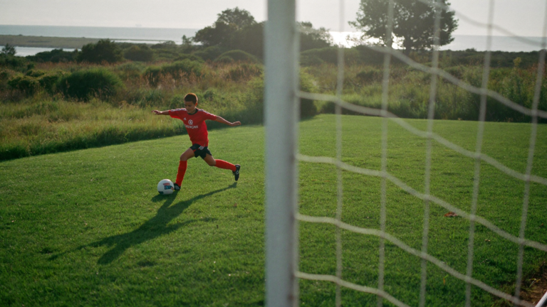 Young soccer player striking a shot on goal during finishing drills in the Charleston Lowcountry