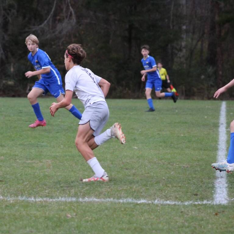 Young players chasing the ball during a match